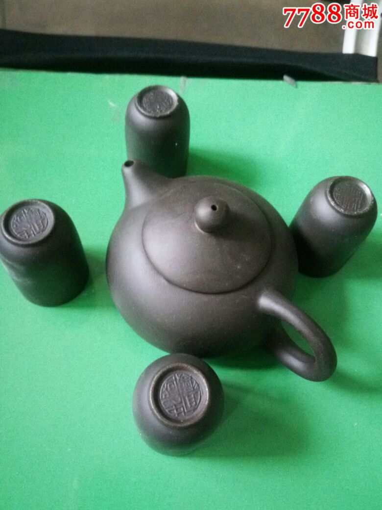 紫砂壶一只,还有四只小杯子,壶和杯子底部有宜兴忠国款